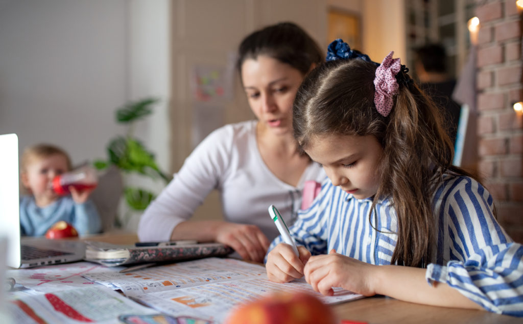 Mother home schooling in the kitchen