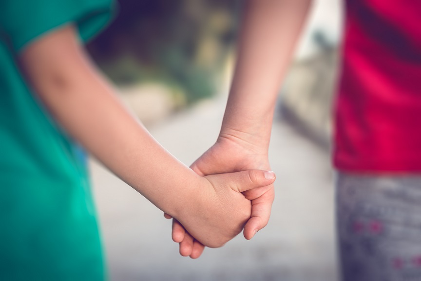 Siblings holding hands together